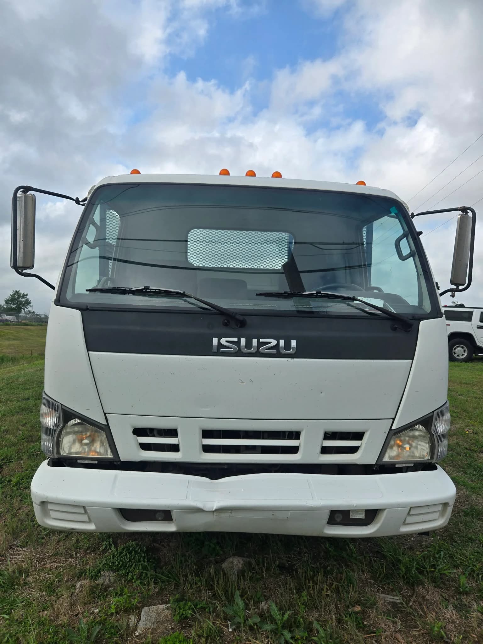 2007 Isuzu NPR stake-bed — photo 1 of 12